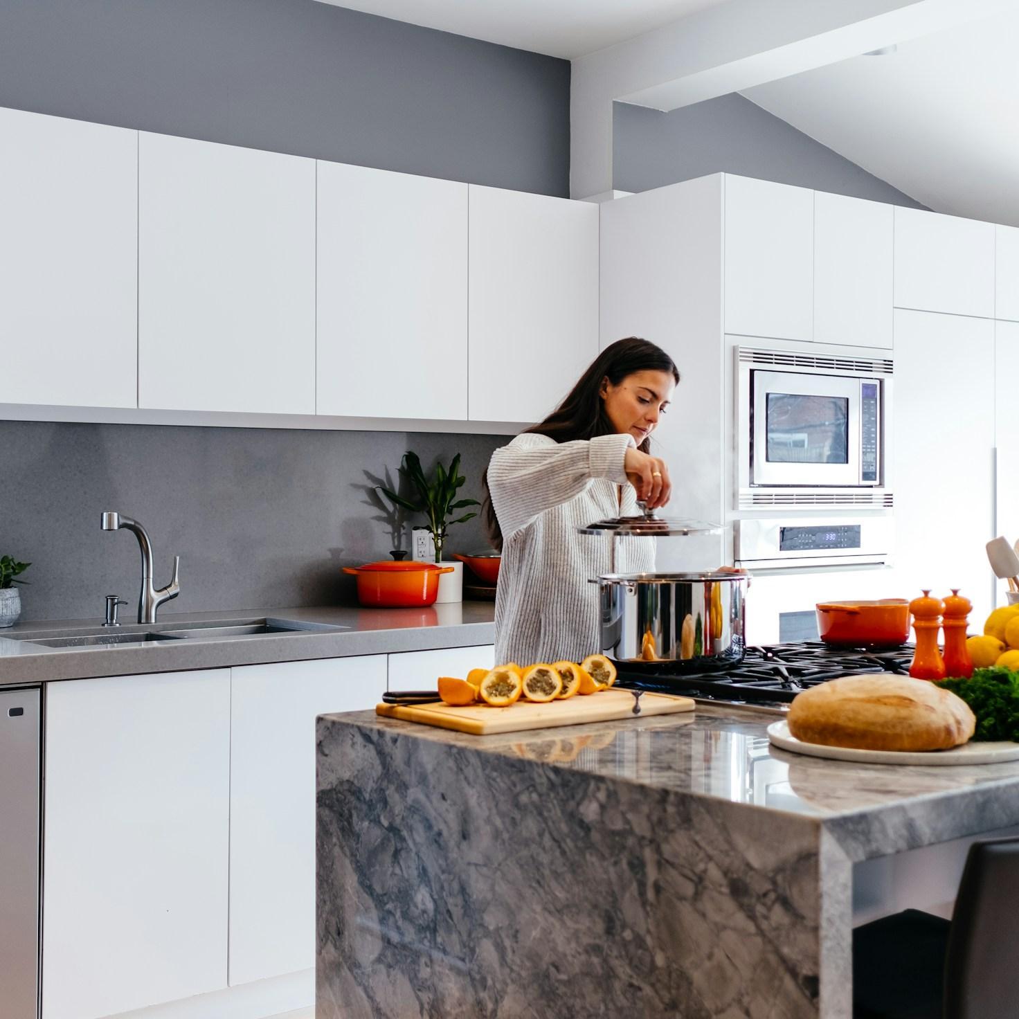 Community members collaborating in a modern kitchen space, sharing recipes and cooking techniques